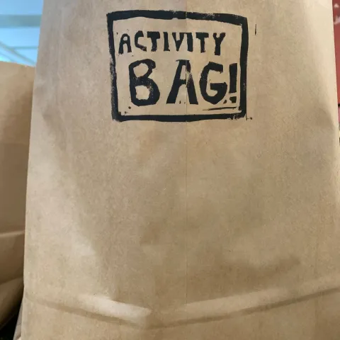 paper bag with activity bag stamped in black ink