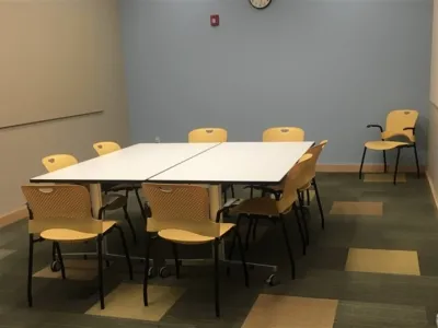 room with 2 tables, 10 charis and glass wall