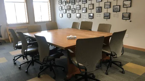 2 large wood tables with 12 chairs and large windows