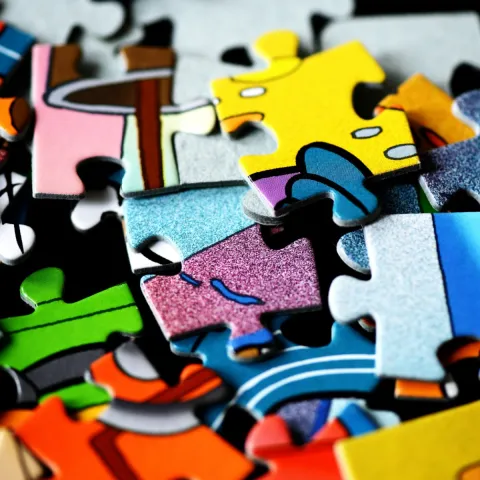 random puzzle pieces in a pile